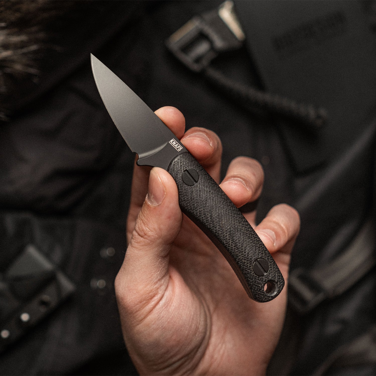 A hand holding Little Lulu Fixed Blade Knife - Black Cerakote MagnaCut - Black Micarta