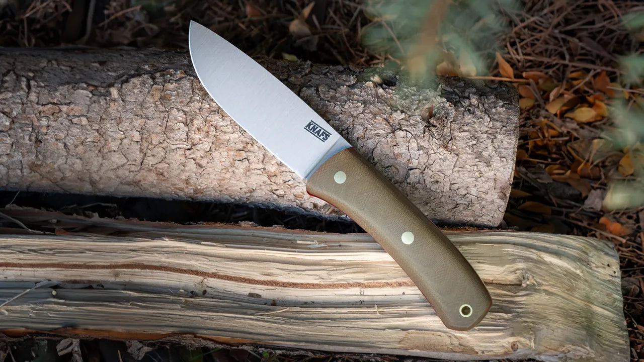 A Knafs knife balanced on timbers outside - best camping knife kit essentials for 2026